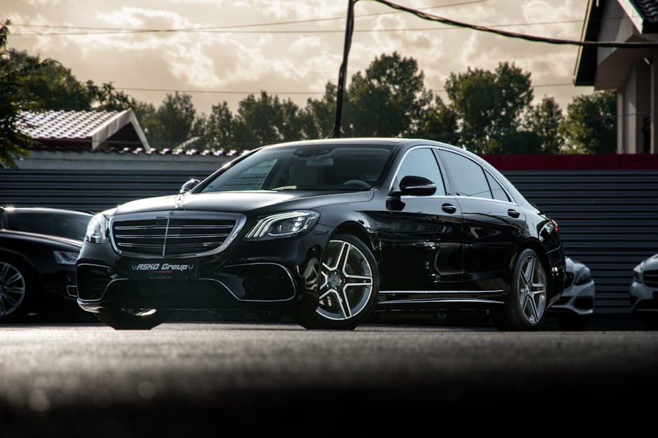 Best chauffeur service in saudi arabia, Sleek black Mercedes S-Class parked on urban street, showcasing luxury design and elegance.
